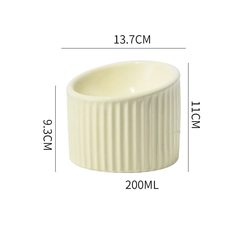Ceramic raised cat bowl in light green colour showing its elevated, tilted round shape.