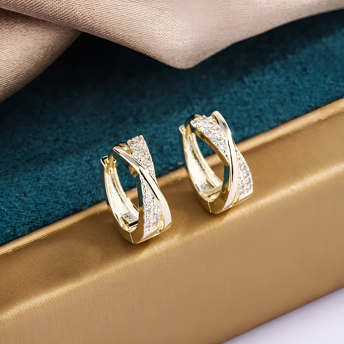 A pair of geometric drop earrings in 14K yellow gold colour, made from copper with a zircon treatment detail.