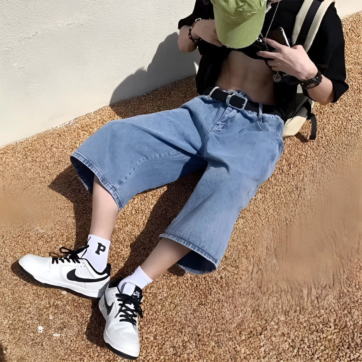 Blue men's cropped high waist denim pirate shorts on a neutral background