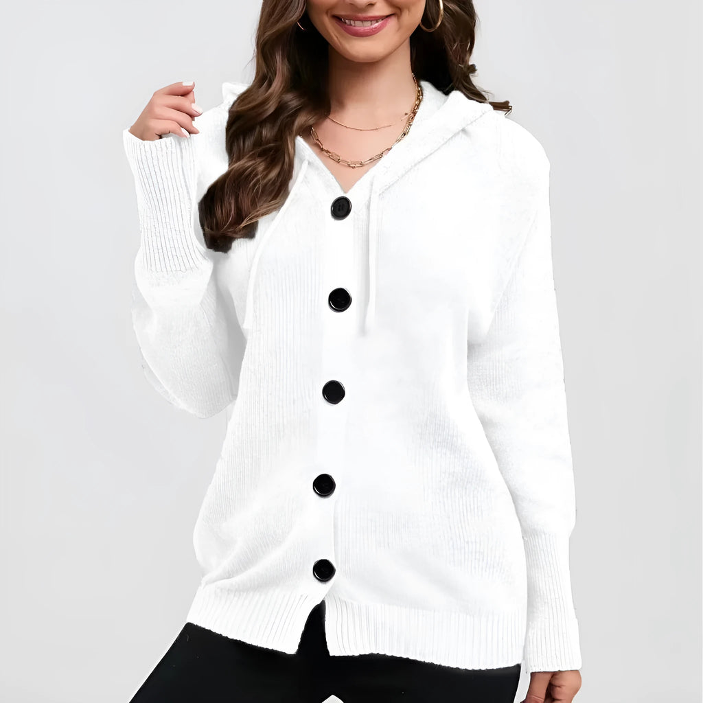 Woman wearing a thick, loose-fit hooded cardigan sweater in a solid colour with a 3D textured pattern.