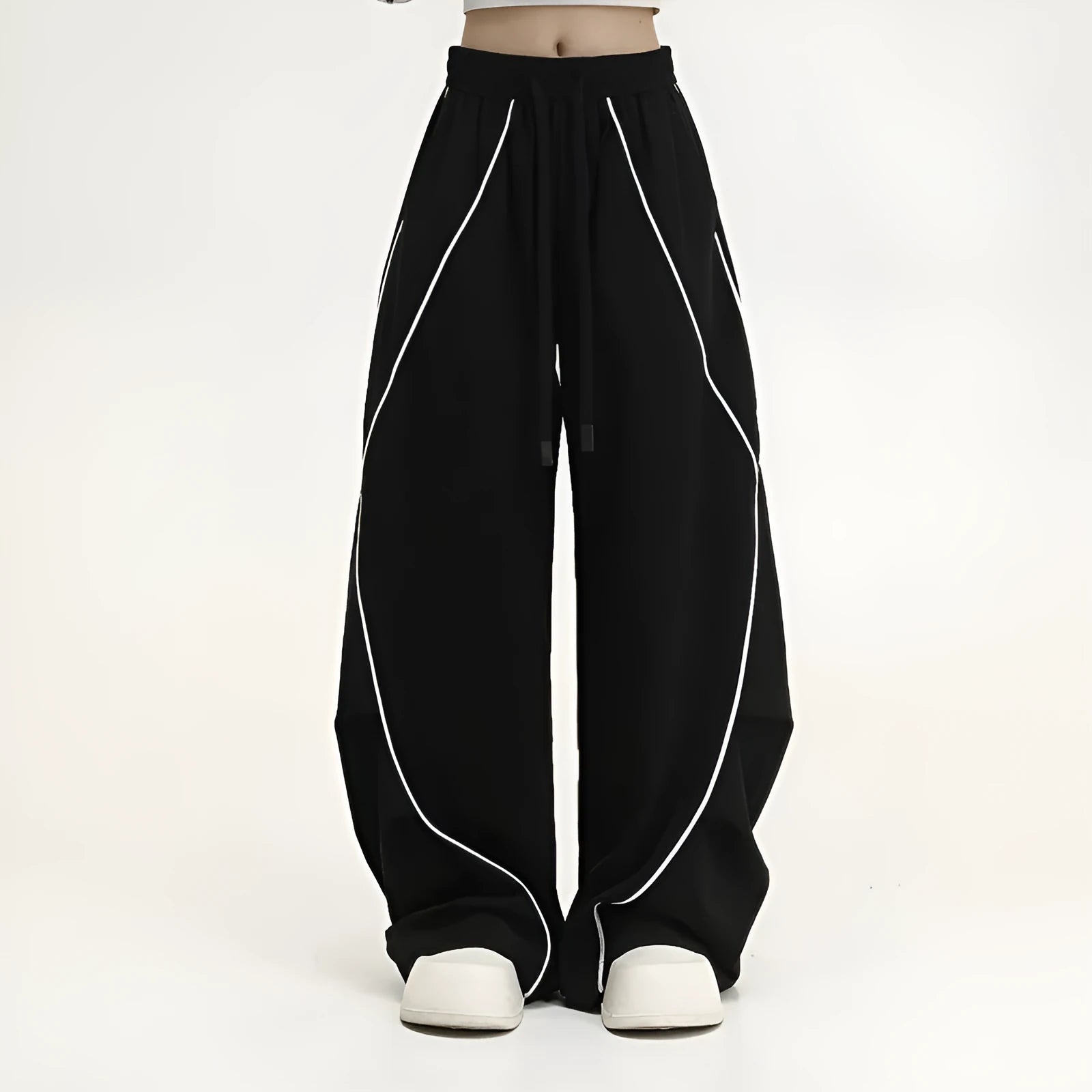 Black and white striped wide-leg hip hop trousers with front pleats on a mid-waist.