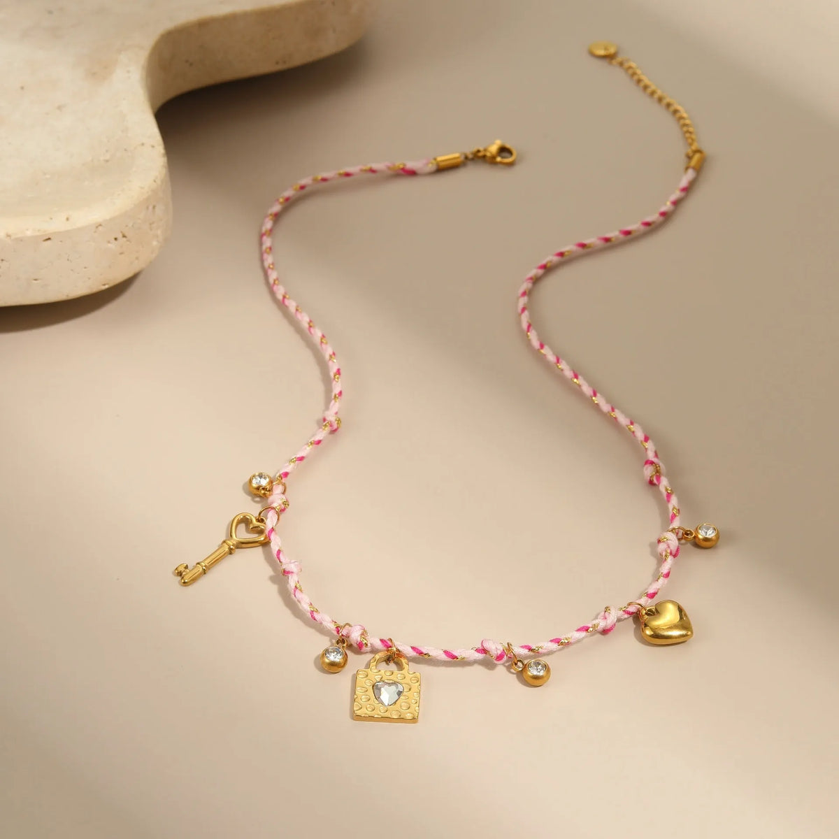Handmade braided rope titanium steel necklace with a choice of purple moon, pink lock, or blue XINGX electroplated pendant.