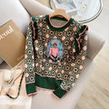 Green women's loose fit printed sweater with regular sleeves on a model.