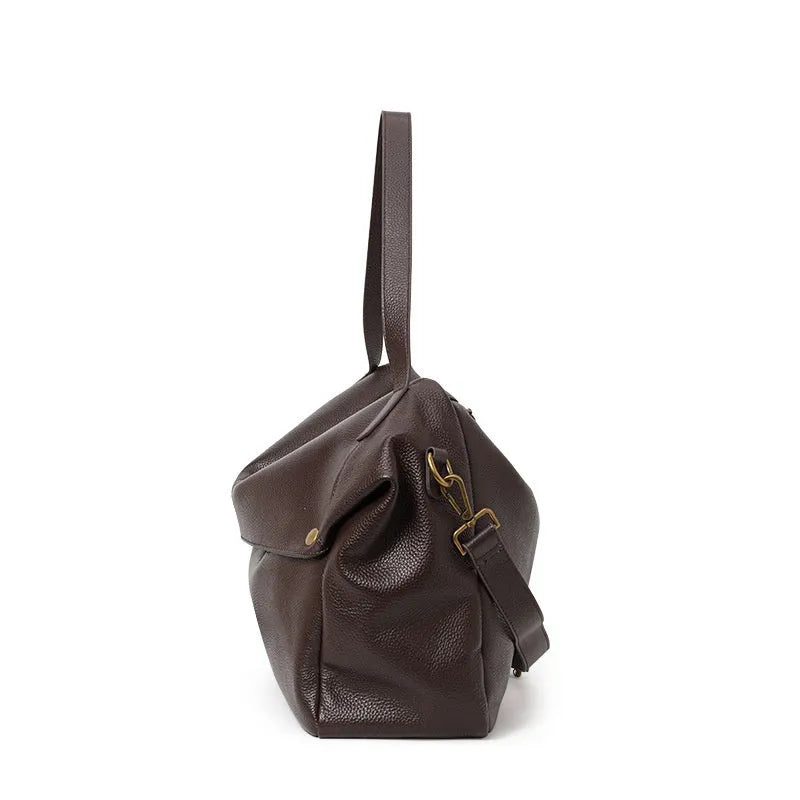 Brown genuine leather women's commuter shoulder bag with horizontal square shape showing internal zippered compartment