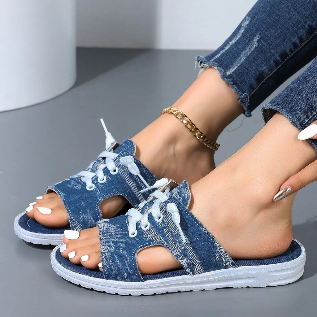 Blue Roman style women's canvas slippers with rubber sole and cloth lining displayed flat