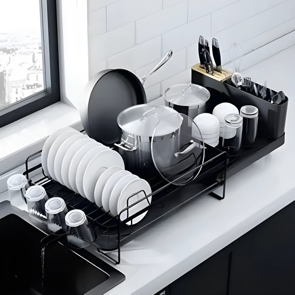 Foldable carbon steel kitchen drain rack for cutlery, knives, forks, spoons, and cups on a worktop.