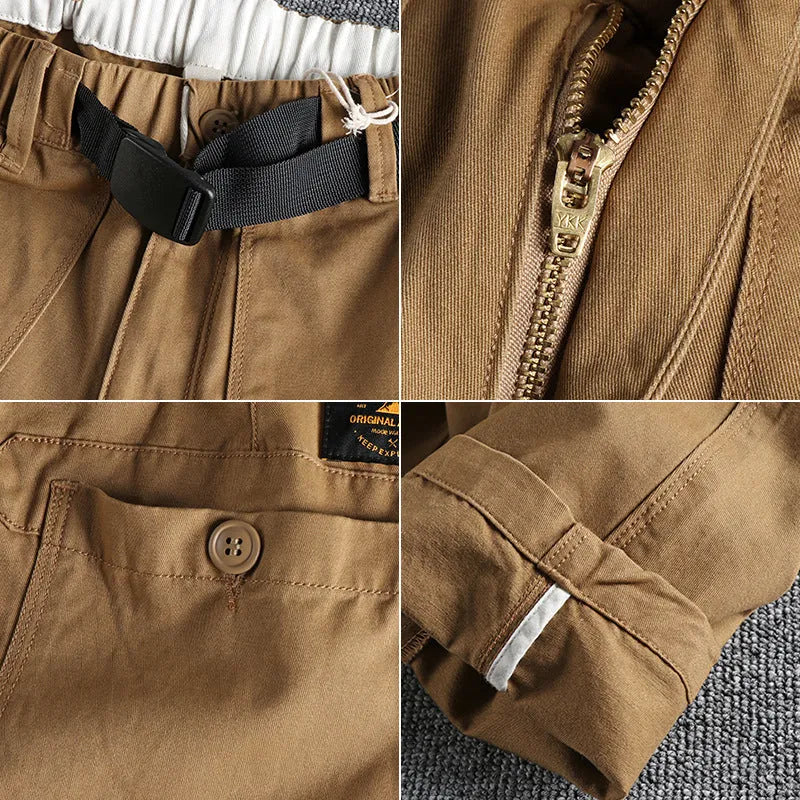 Men's khaki cotton work trousers with an N I buckle belt on a mid-rise waist.