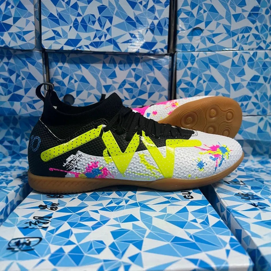 Low-top soccer shoes in black and yellow colour with a PVC upper and rubber studded outsole.