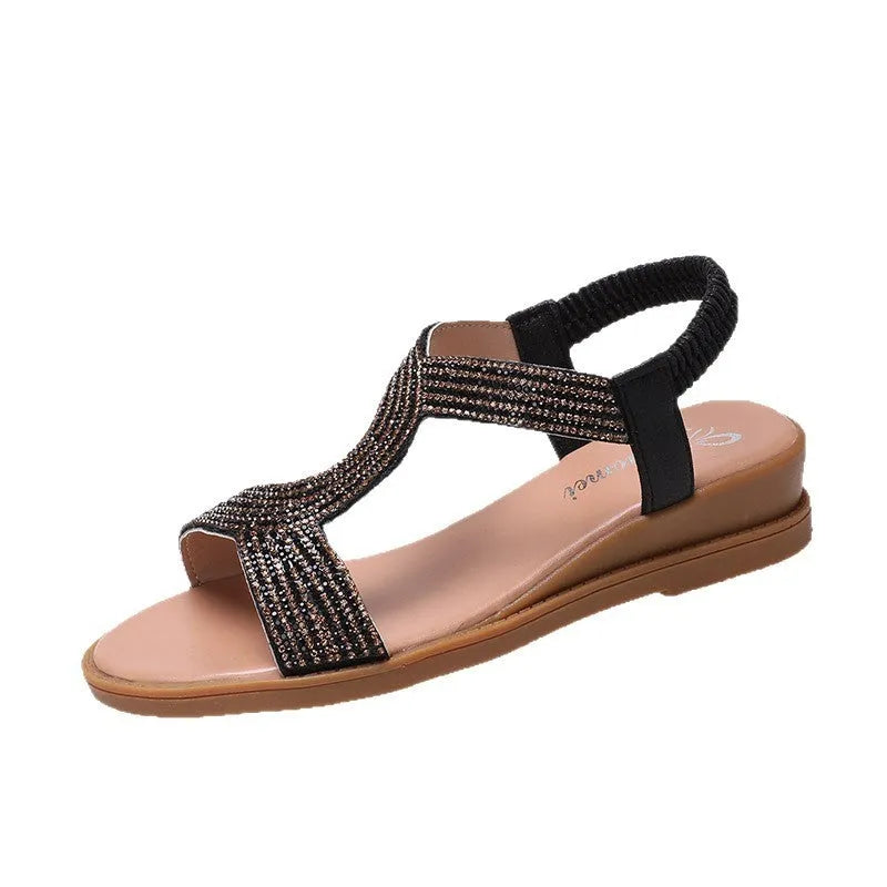 Gold patent leather women's thong sandals with rhinestone accents and a non-slip sole.
