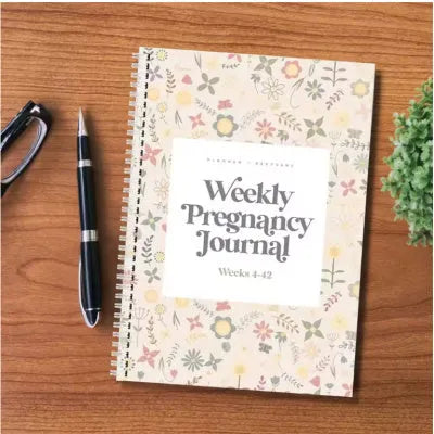 A5 pregnancy weekly diary notebook open showing weekly formatting pages