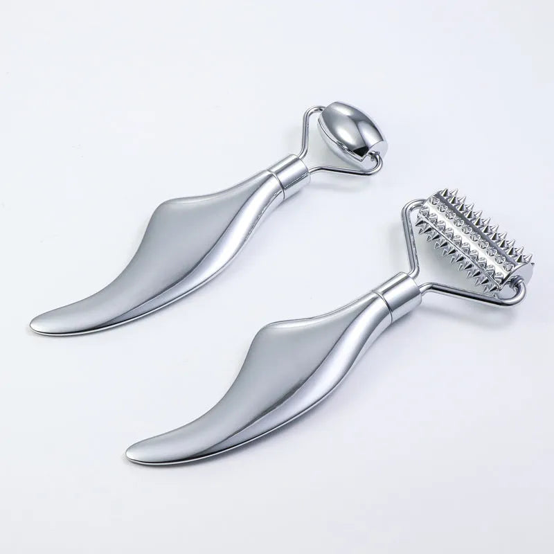 Stainless steel double-headed facial roller and gua sha scraping plate set with heart-shaped eye tool.