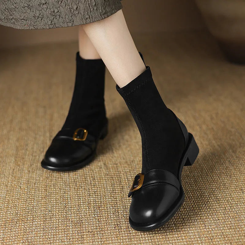 Women's black low heel Martin boots with front lace-up and buckle stitch detail on a round toe.