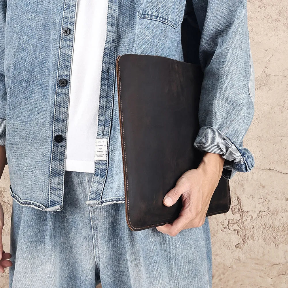 Brown genuine cowhide leather horizontal computer liner bag with a solid colour pattern.