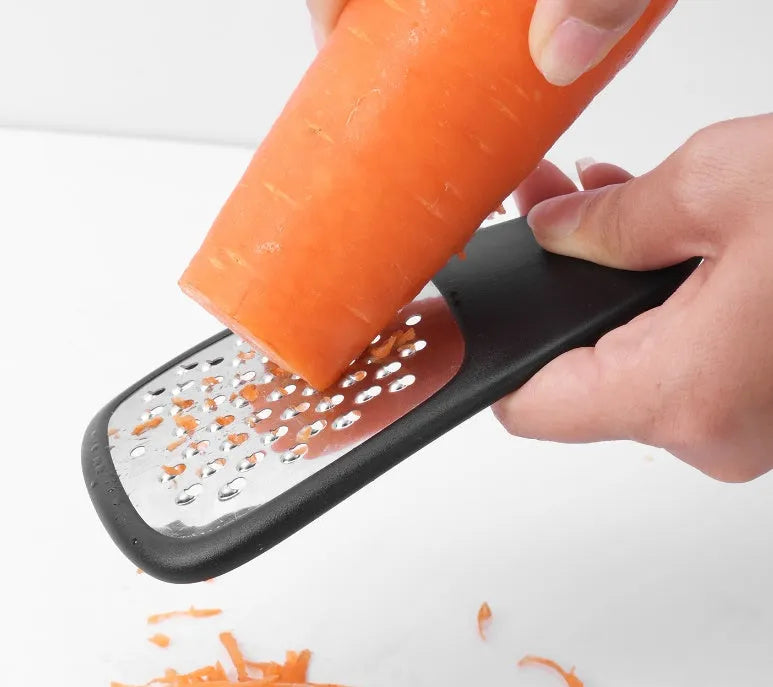 Six kitchen gadgets stacked together with cleaning brush in colour box packaging