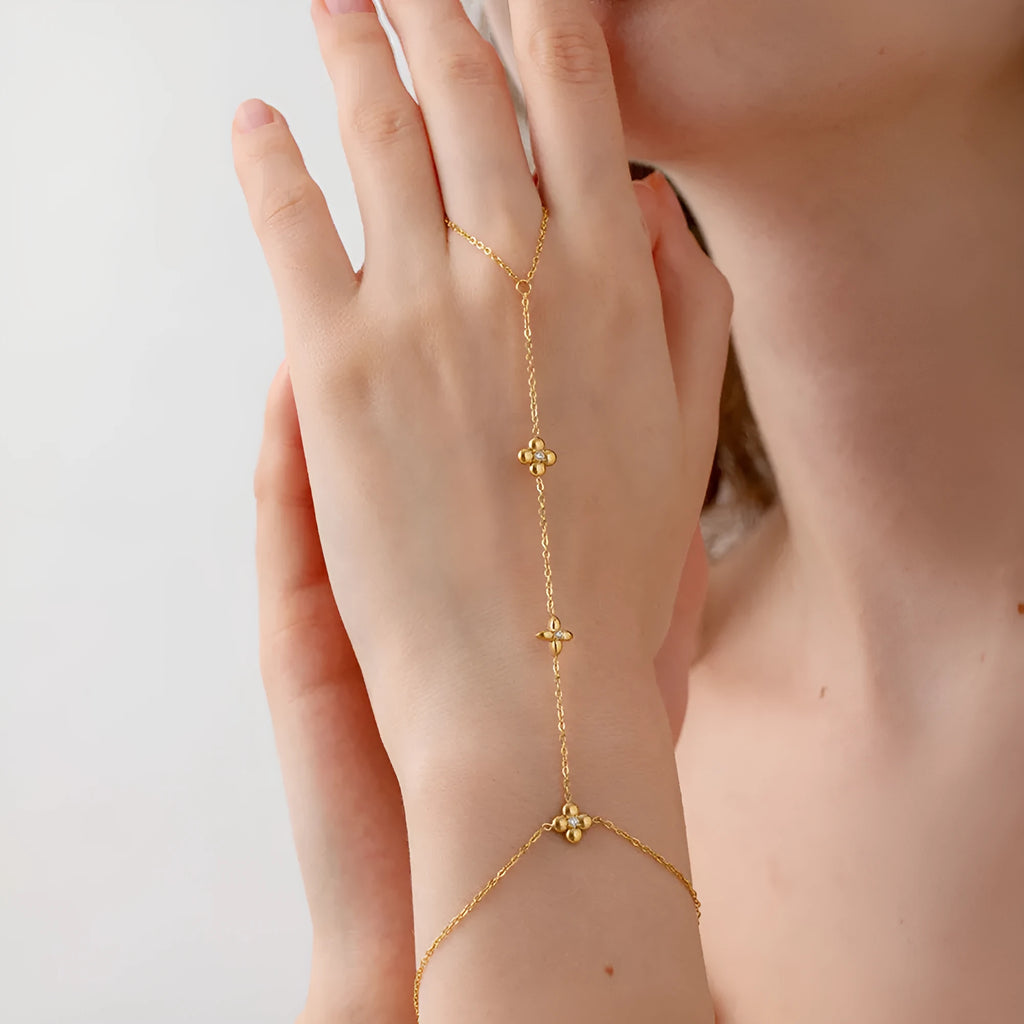 Gold-coloured women's bracelet with floral and eight-pointed star design on stainless steel