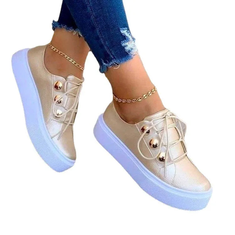 Women's white lace-up flats sneakers with round toe and silver rivet detail on the artificial PU upper.