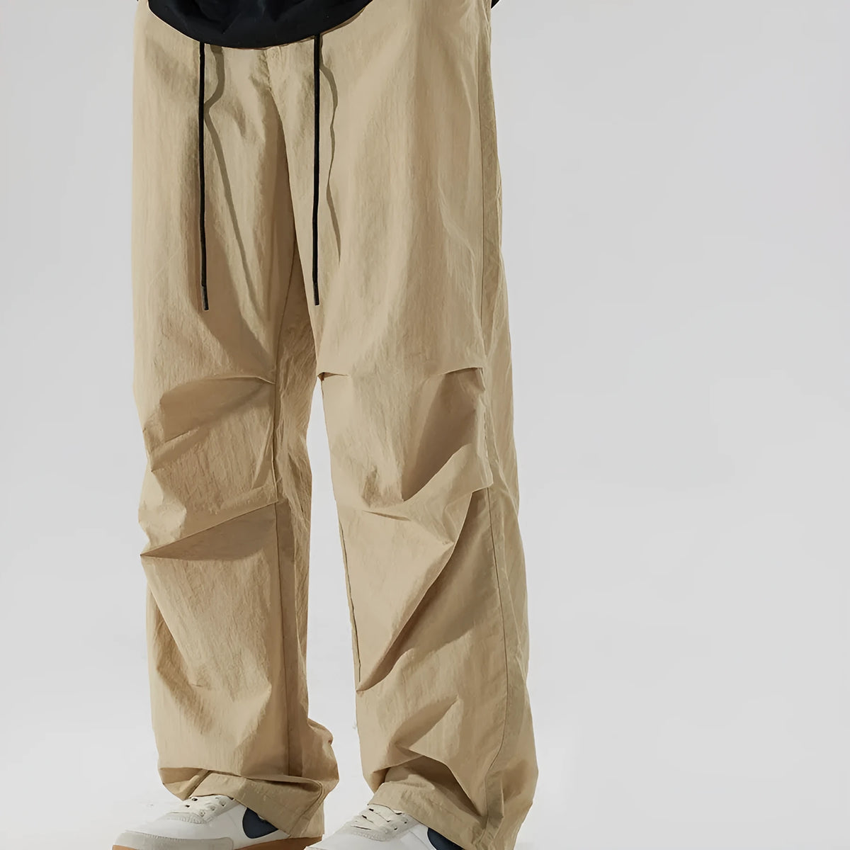 Men's straight-leg loose fit casual trousers in nylon fabric, shown in various colours including black and army green.