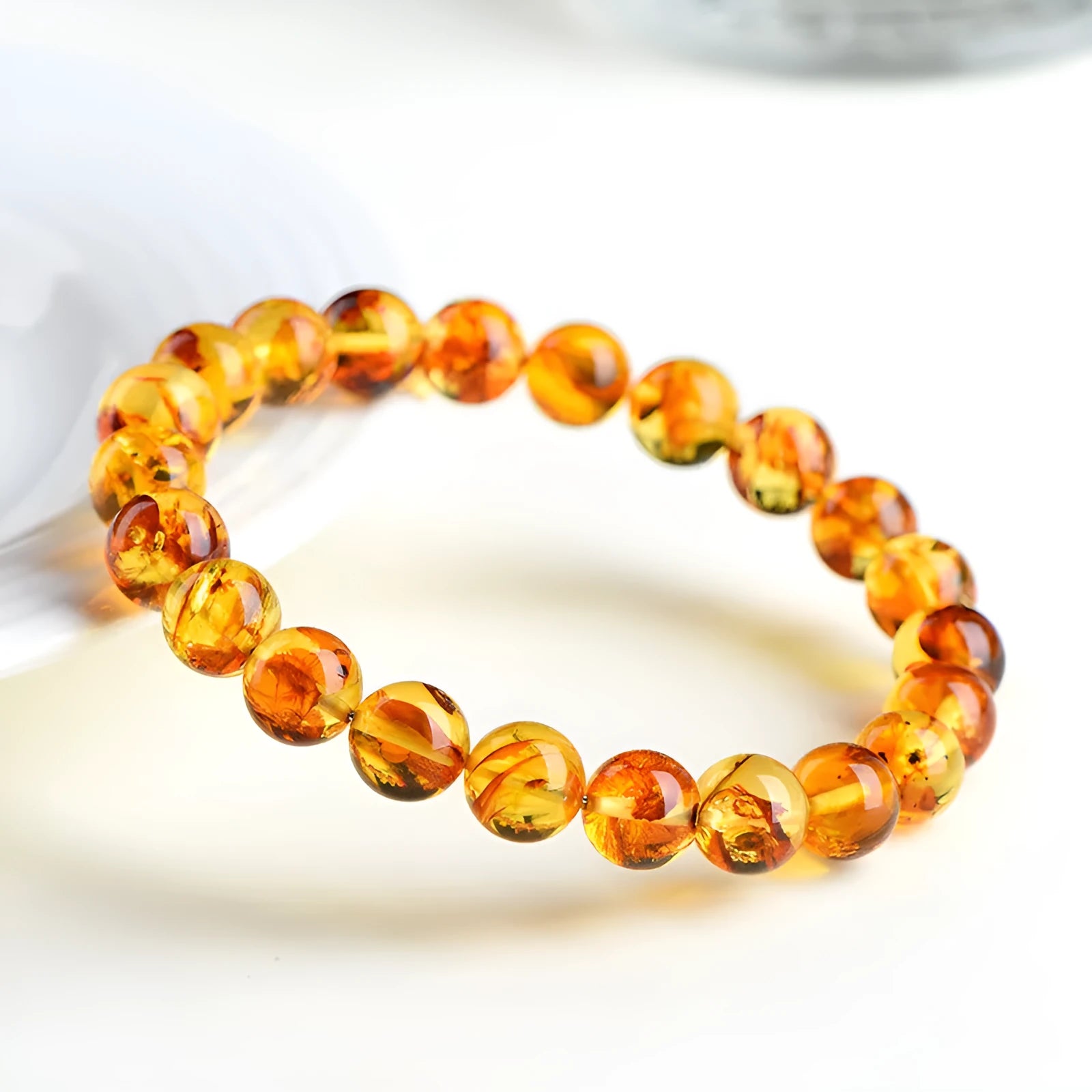 Natural yellow piebald amber bracelet with polished geometric beads on a wrist.