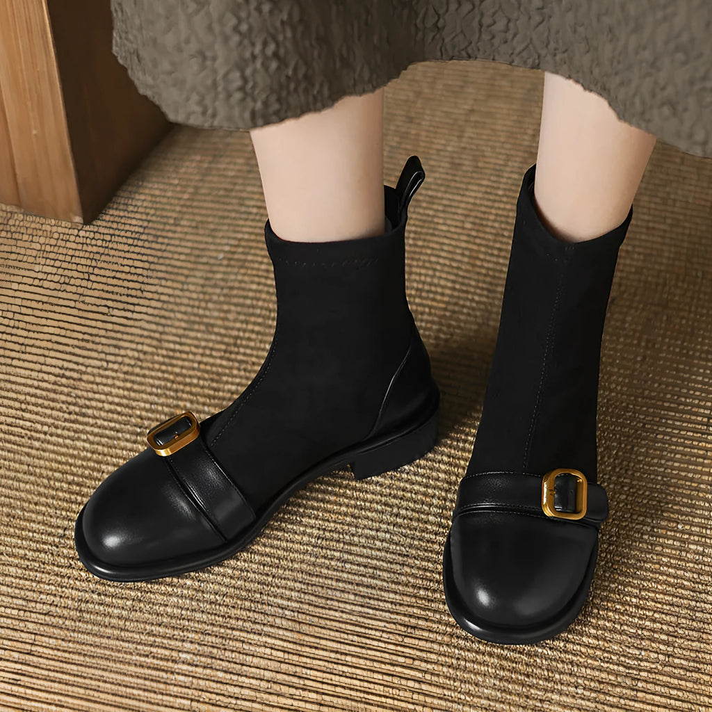 Women's black low heel Martin boots with front lace-up and buckle stitch detail on a round toe.