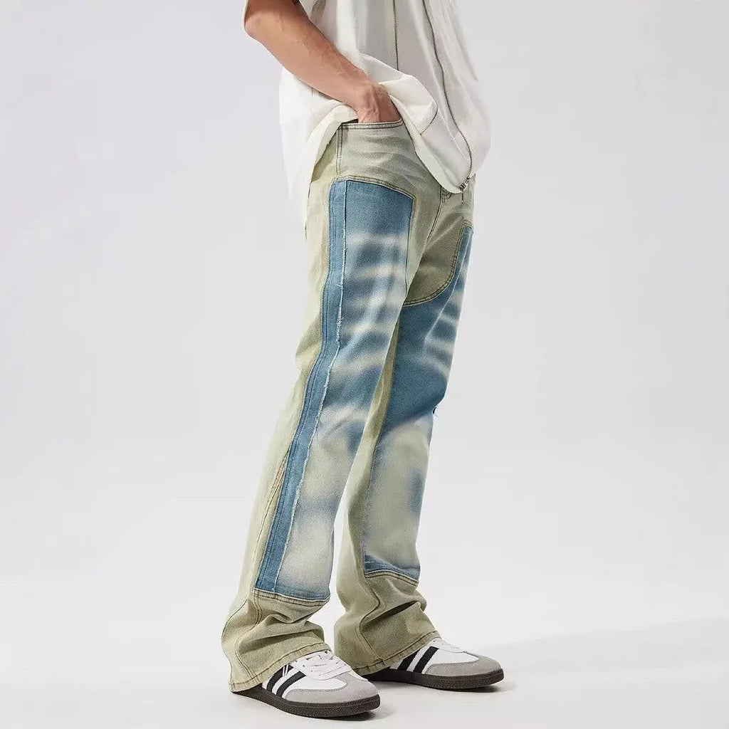 Yellow and blue retro jeans with patchwork and splash-ink damaged design, mid-waist cut.