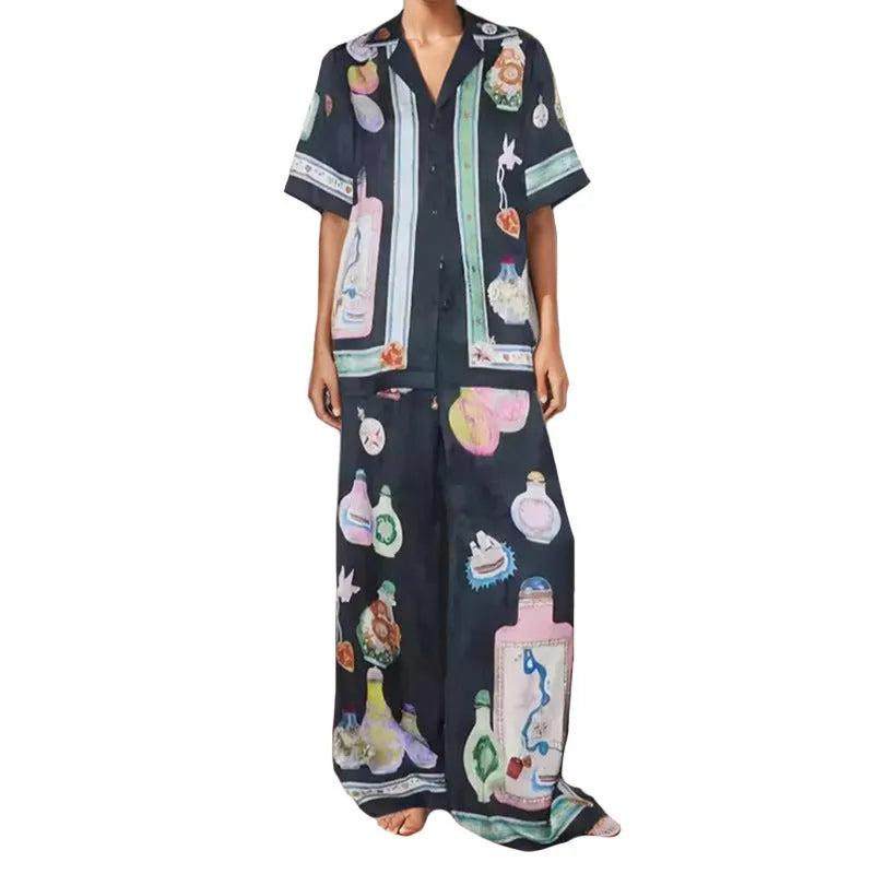 Women's black polyester co-ord set with cartoon animation print showing cardigan and trousers