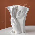 Ceramic book stand with glazed surface in a modern design, displayed on a desktop.