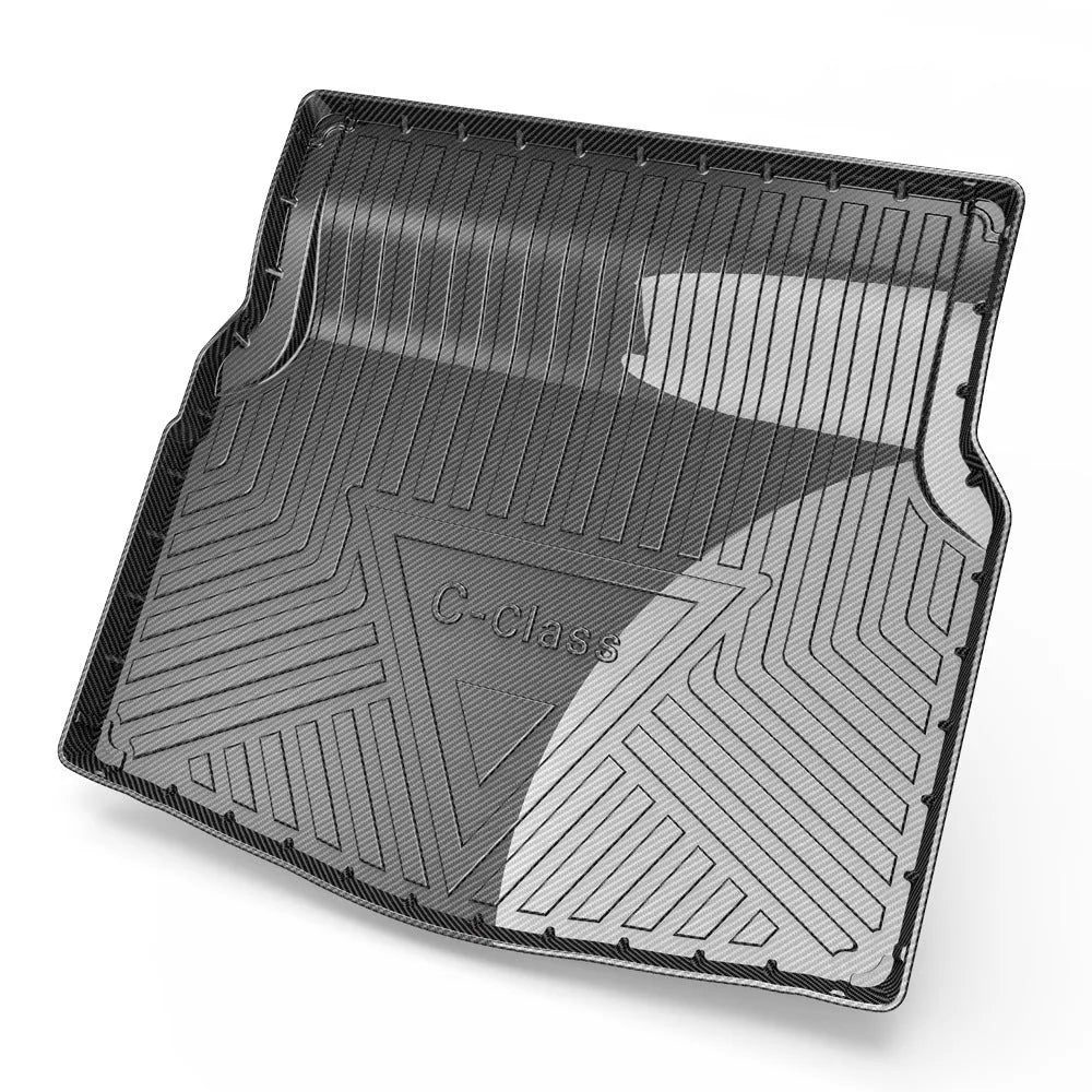 Black TPE car boot liner with carbon fibre pattern texture, shown fitted in a vehicle trunk.