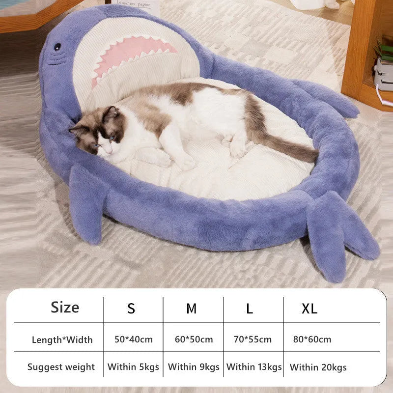 Blue shark pattern pet bed cushion for dogs or cats on a wooden floor.