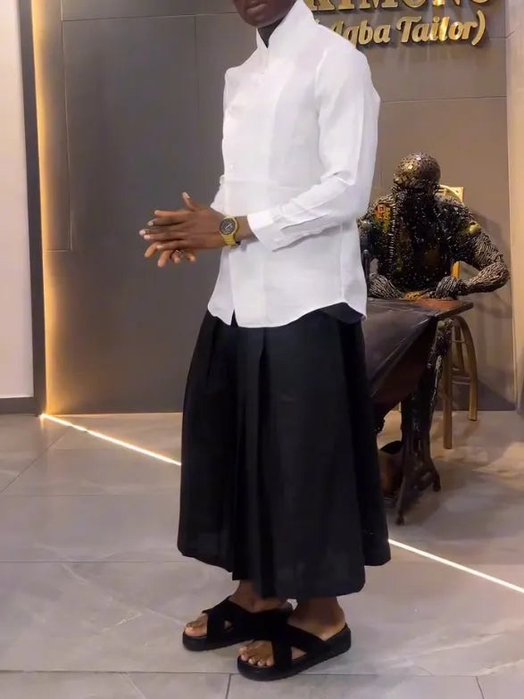 White asymmetric long sleeve shirt paired with black pleated pants in casual two-piece set