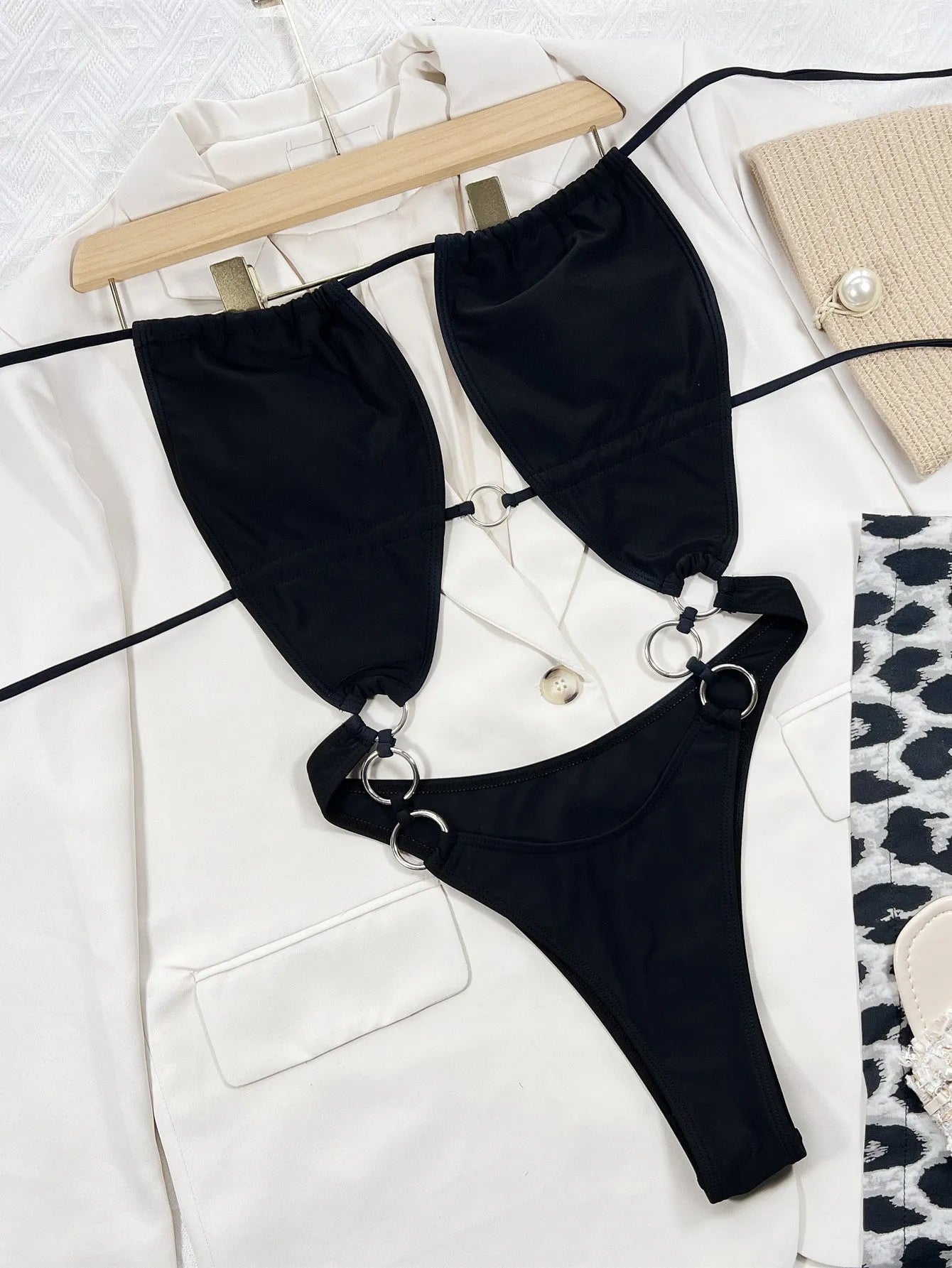 Black women's one-piece swimsuit with steel ring detail and sleeveless design