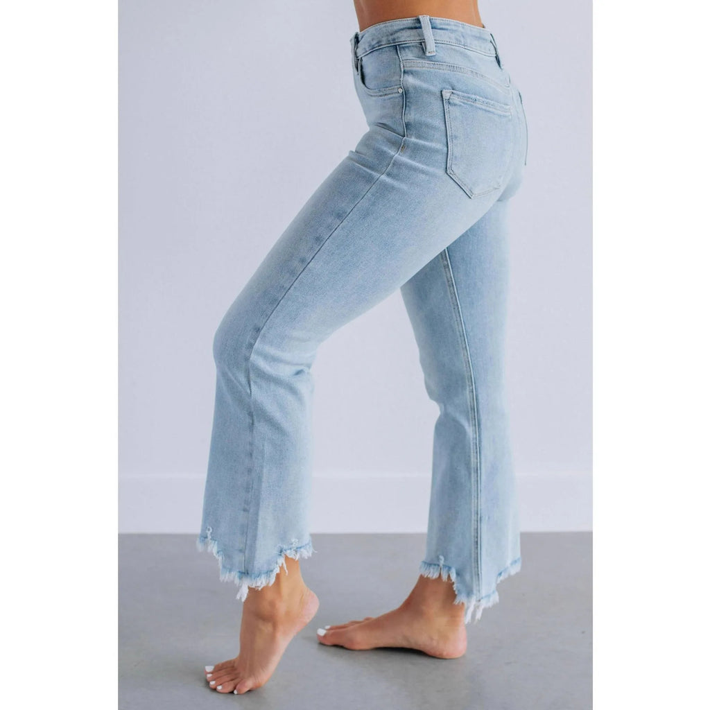 Women's dark blue casual denim jeans with hand-worn distressing on a solid cotton fabric