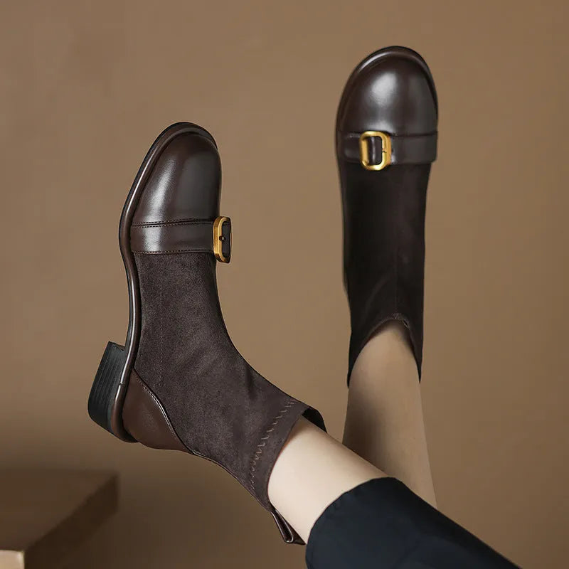 Women's black low heel Martin boots with front lace-up and buckle stitch detail on a round toe.