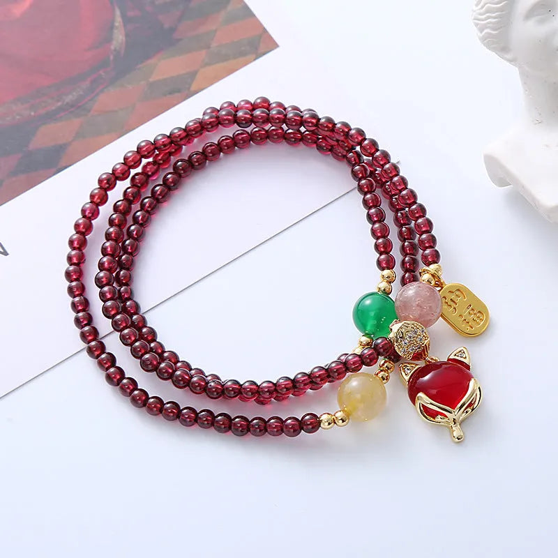 Purplish red garnet fox charm bracelet with adjustable cord fastening for women
