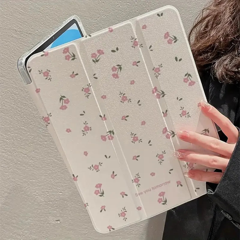Transparent floral tri-fold iPad protective case with built-in stand, shown closed with magnetic clasp.