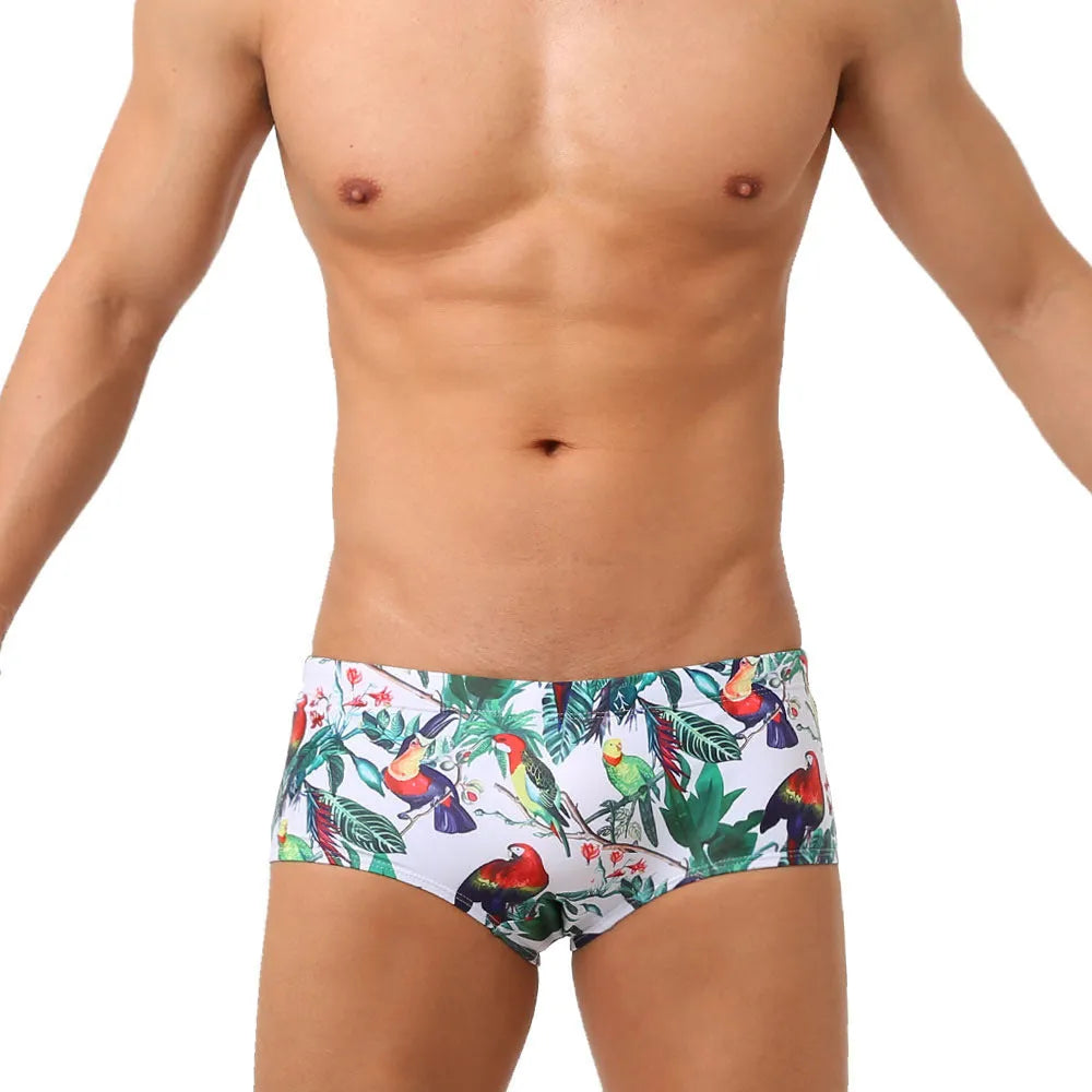 Men's floral bird print nylon swim trunks in boxer style on white background