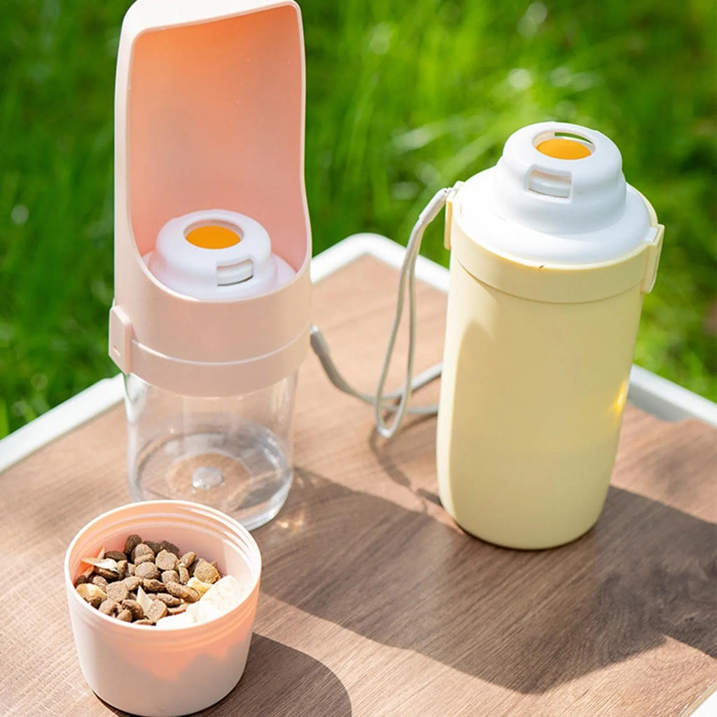 Green 2-in-1 travel dog water bottle and food container with attached lanyard, shown folded.