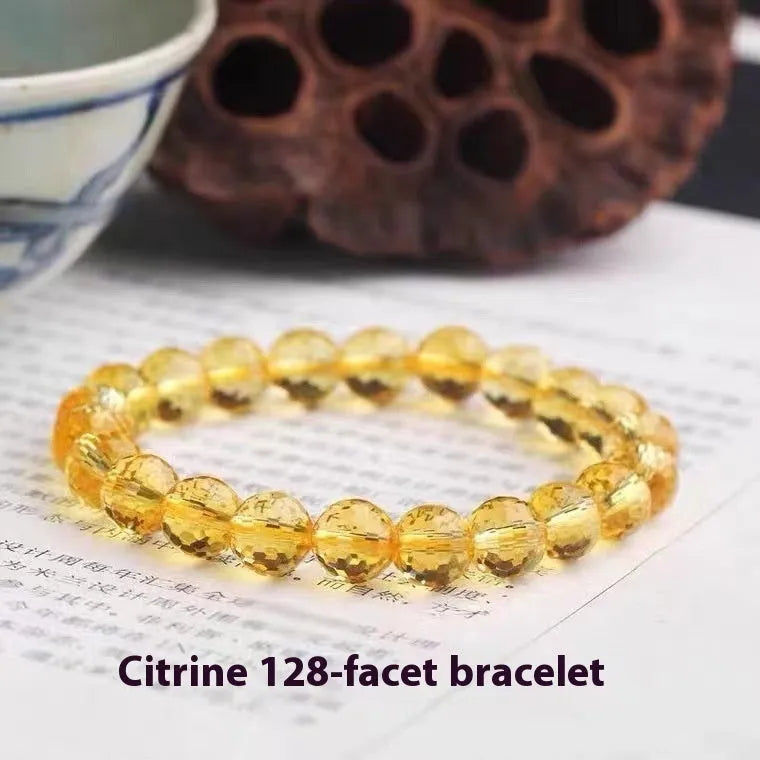 Hand-crafted ametrine bracelet with 128-facet cut crystal beads on a wrist.