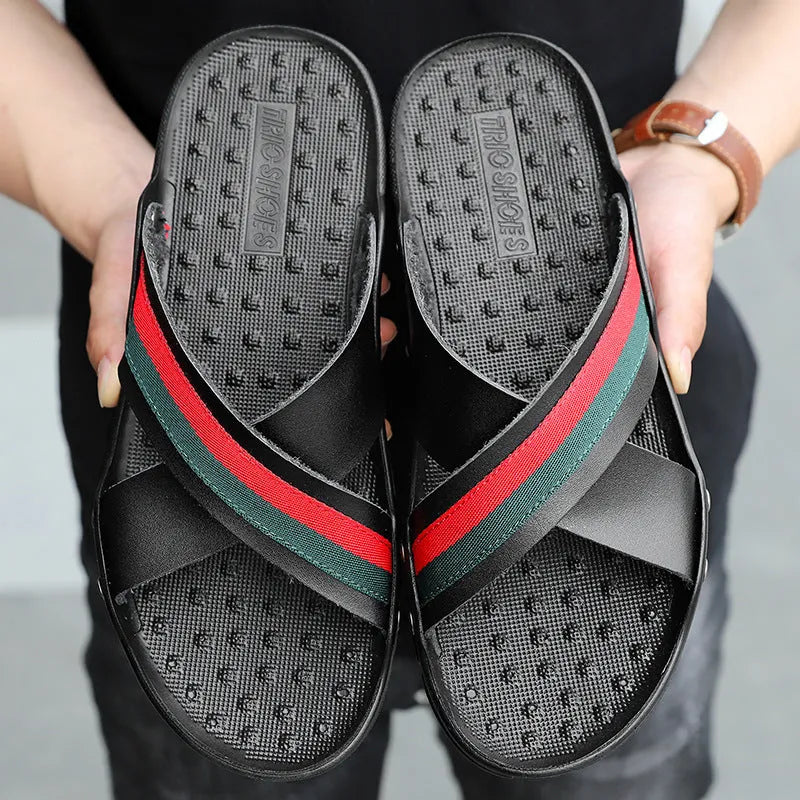 Men's white cowhide leather flip-flops with a textured non-slip PU sole on a sandy beach.