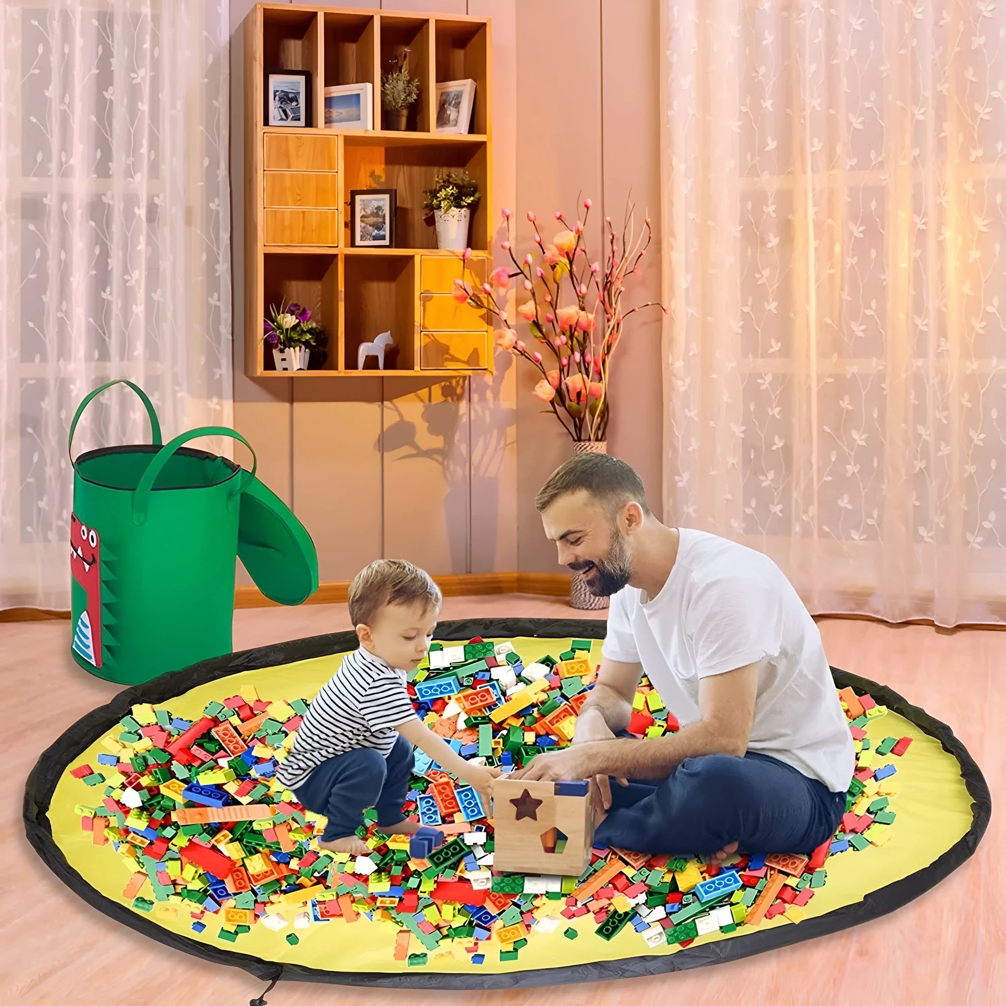 Green cube-shaped felt storage bag with pull rope, laid flat as a play mat.