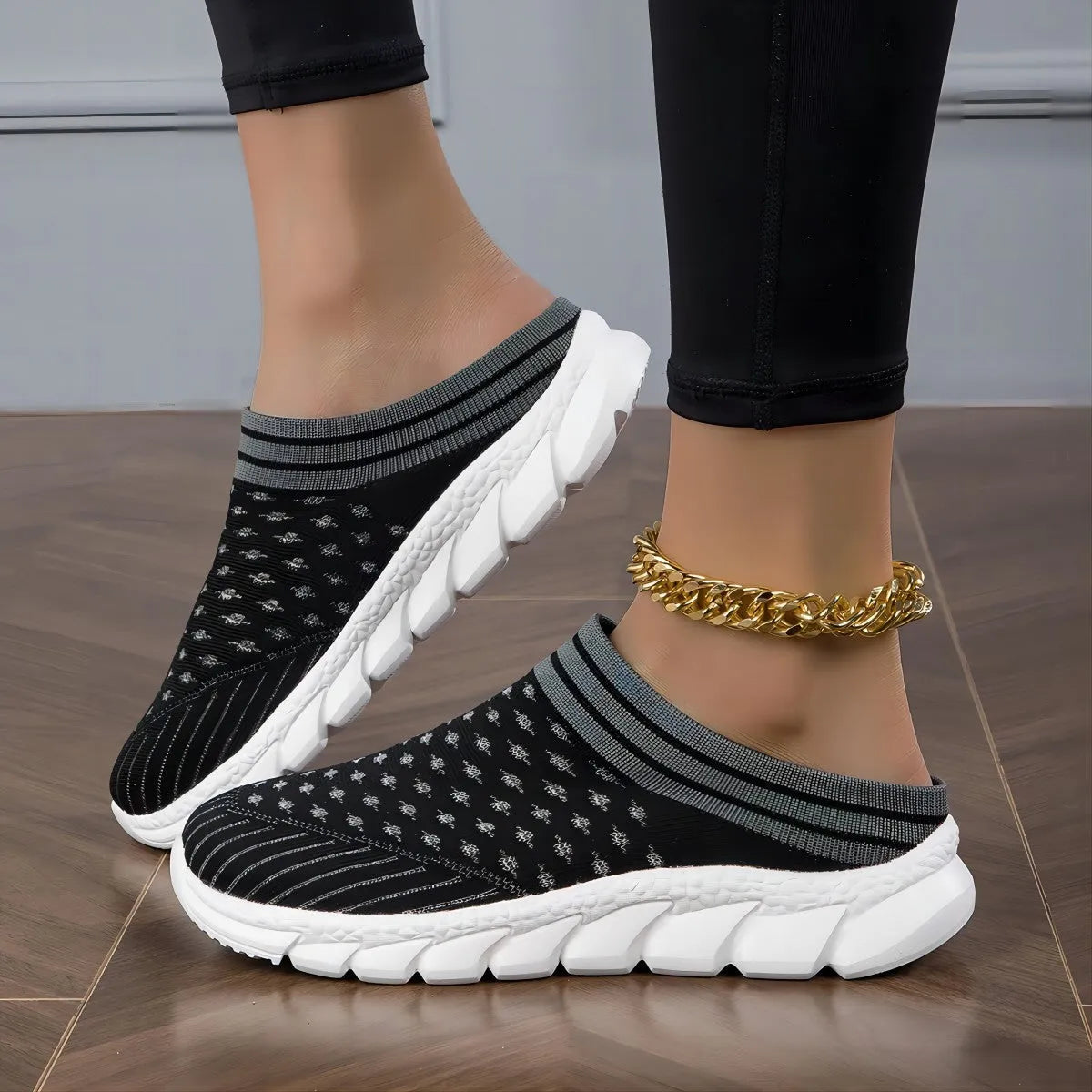 Women's black flyknit slippers with hollowed-out pattern and a height-increasing viscose sole.