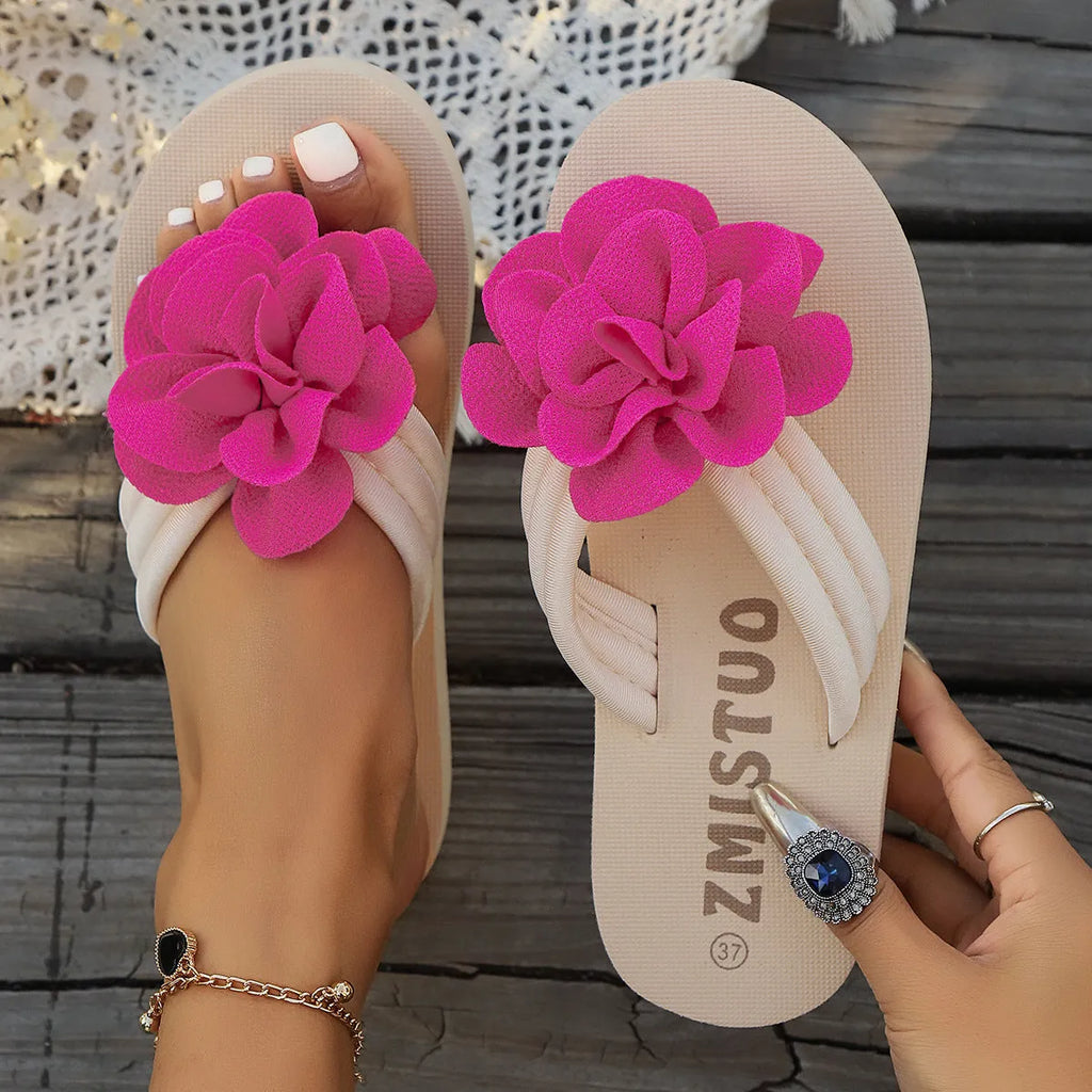 A pair of plus size floral design flip flop slippers in creamy-white with a PU upper and sole.