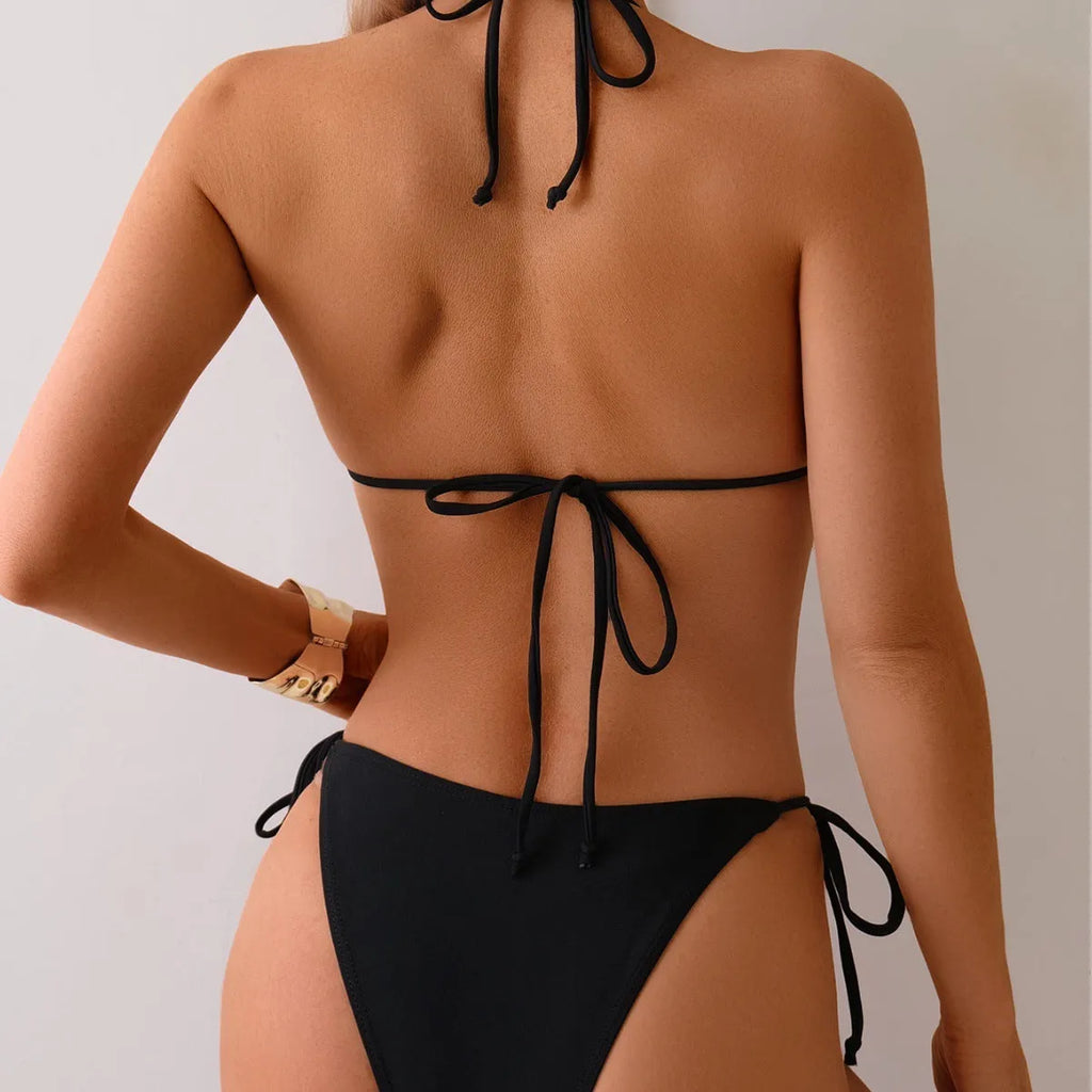 Black women's bikini swimsuit with metal bead decoration and split design