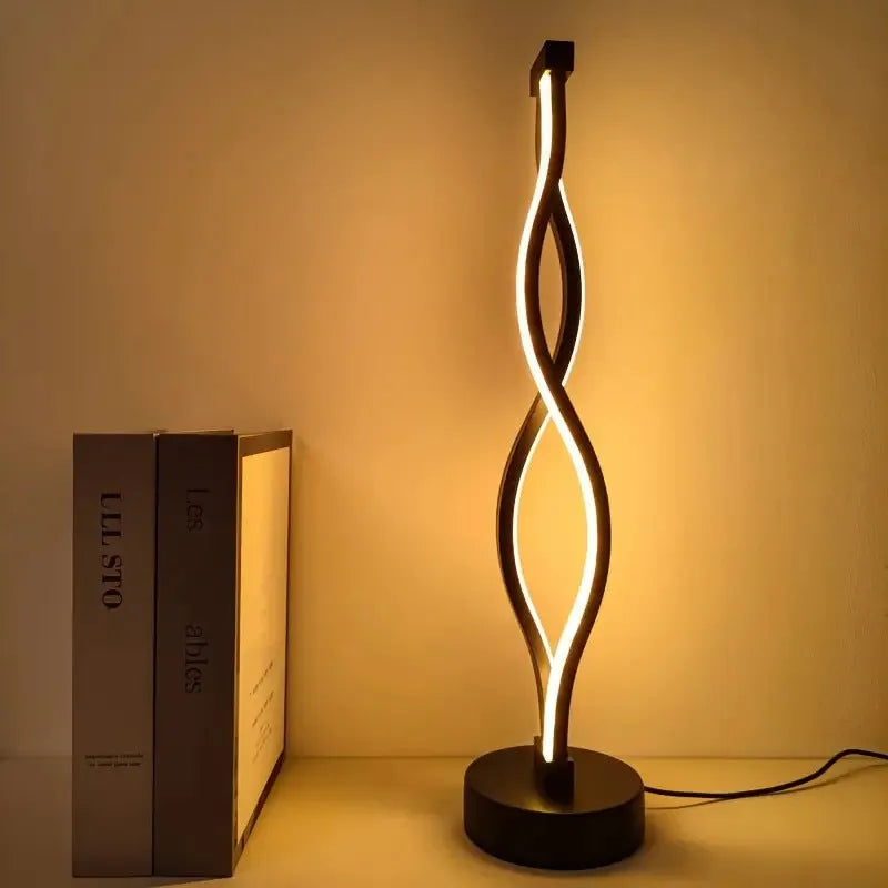 Black aluminium desk lamp with touch dimming and a three-colour button on a desktop