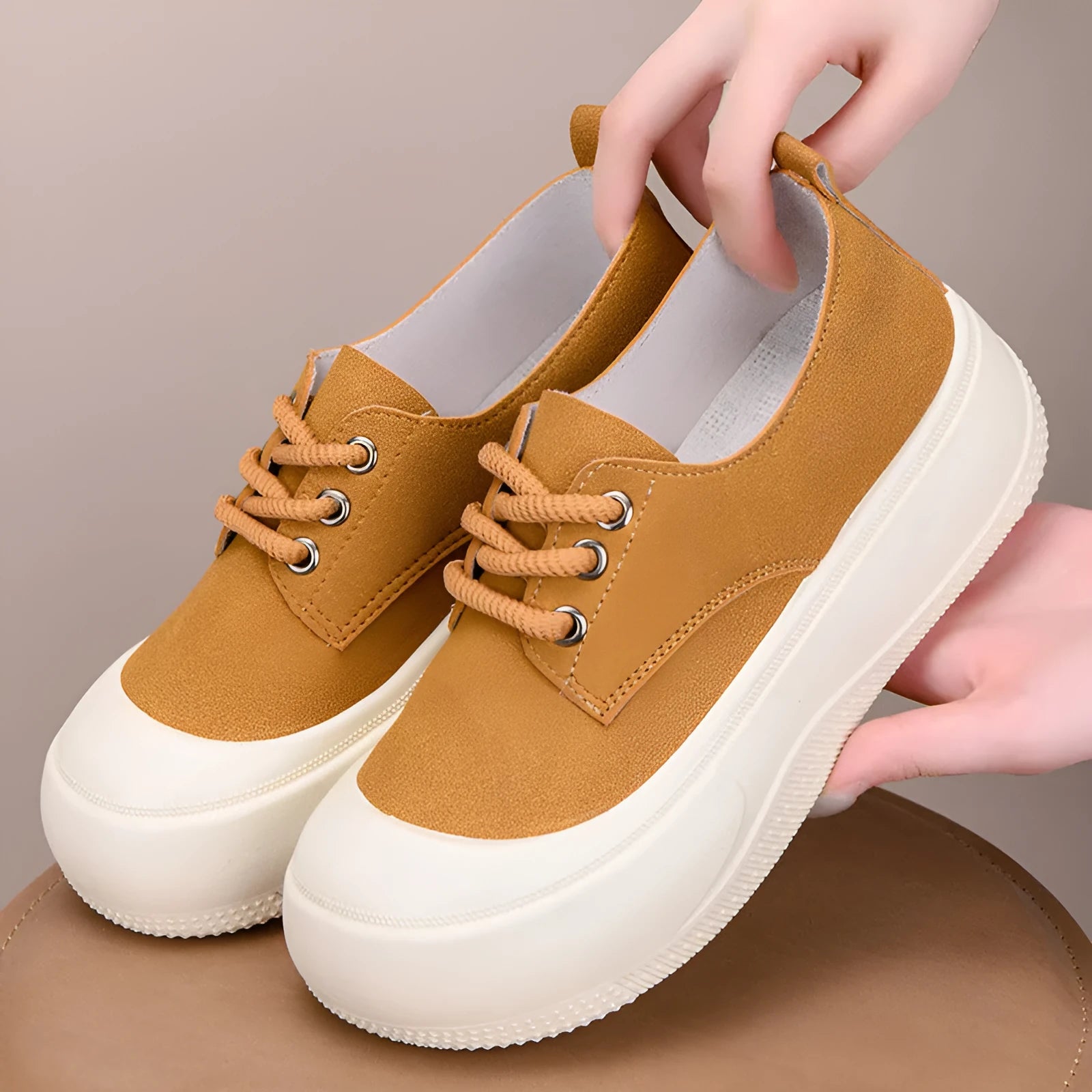 Women's camel suede platform loafers with round toe, flat heel, and front lace-up.