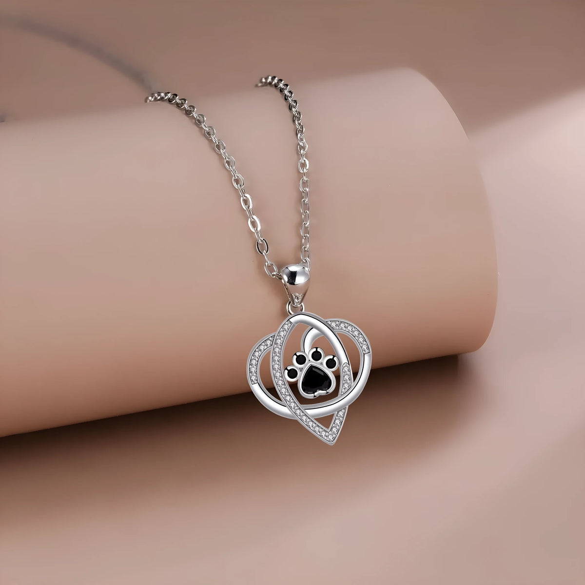 Women's copper necklace with dog and cat paw print pendant on cross chain
