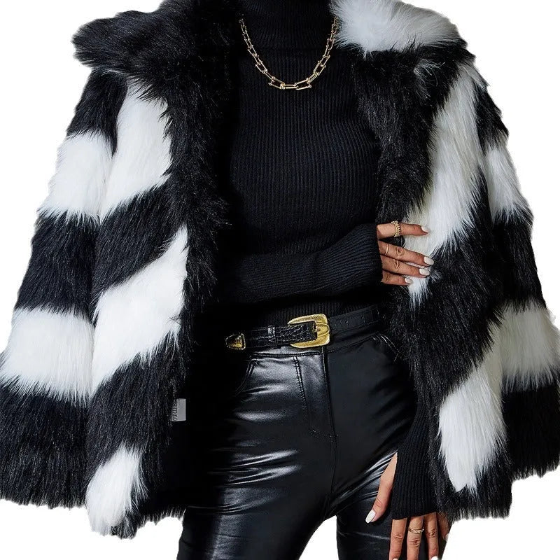 Women's beige faux fur lapel coat with a dark contrast fur collar on a hanger.