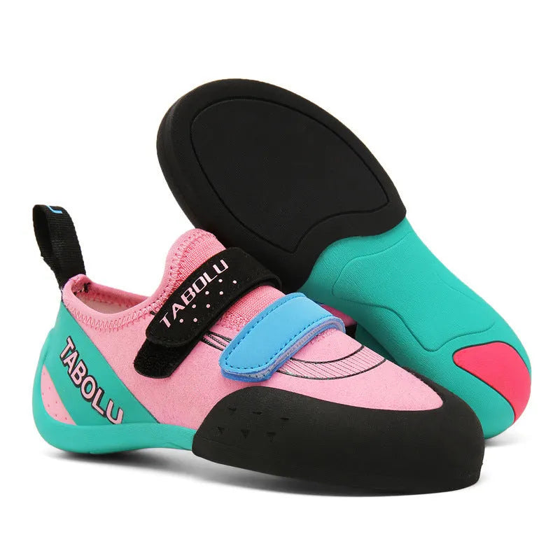Beginner rock climbing shoes in black and red with Velcro strap and rubber sole.