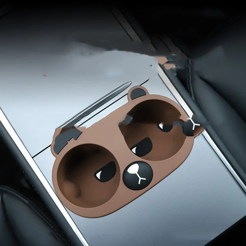 A grey silicone insert designed to fit into a car's central console cup holder to stabilise drinks.