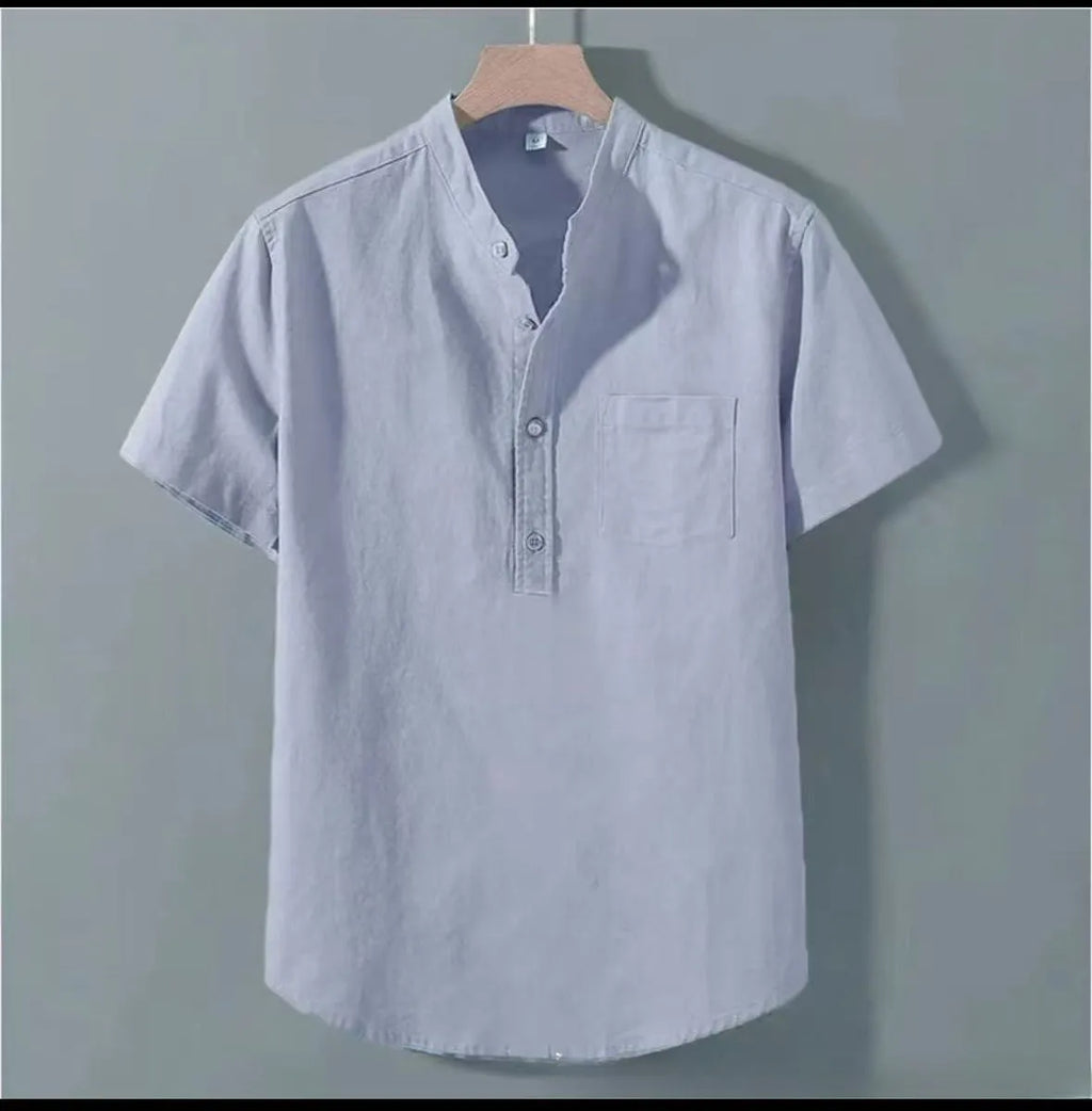 A man's casual beige slub linen shirt with a stand collar and short sleeves, laid flat to show its loose fit.