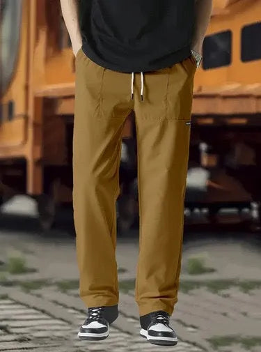 Men's polyester trousers for spring and autumn in light grey colour, showing casual fit.